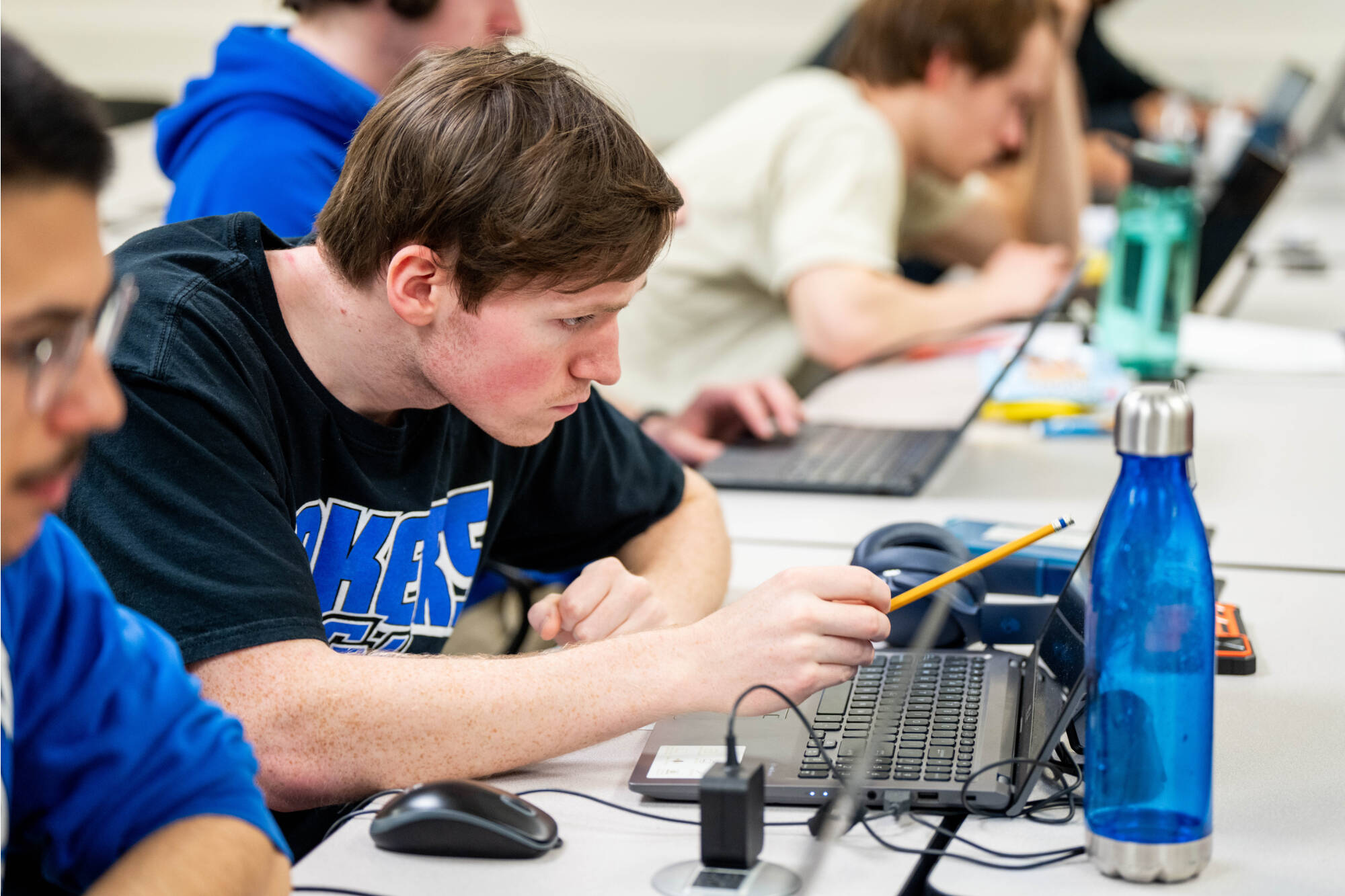 Student Joshua Wiles looks intently at. his computer screen during a Cybersecurity Capture the Flag event on February 10, 2024 in Mackinac Hall.